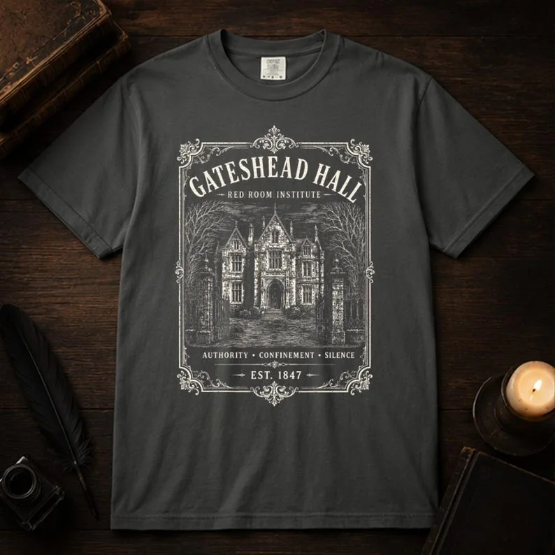 Flat lay of Pepper Comfort Colors Jane Eyre Gateshead Hall gothic t-shirt with high-contrast Victorian manor engraving print