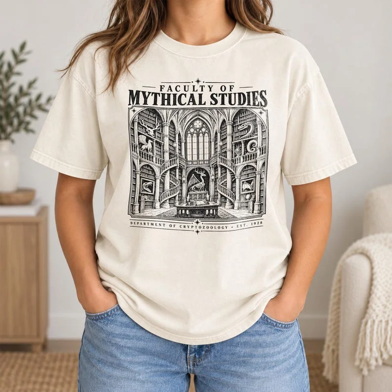 Ivory Comfort Colors Mythical Studies shirt with black Faculty of Mythical Studies Gothic library graphic.