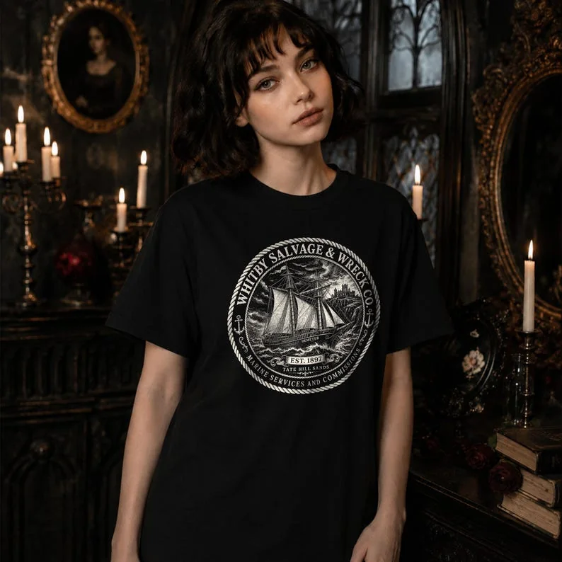 Woman wearing black Whitby Salvage and Wreck Co T-shirt featuring a vintage ship illustration inspired by Bram Stoker’s Dracula.